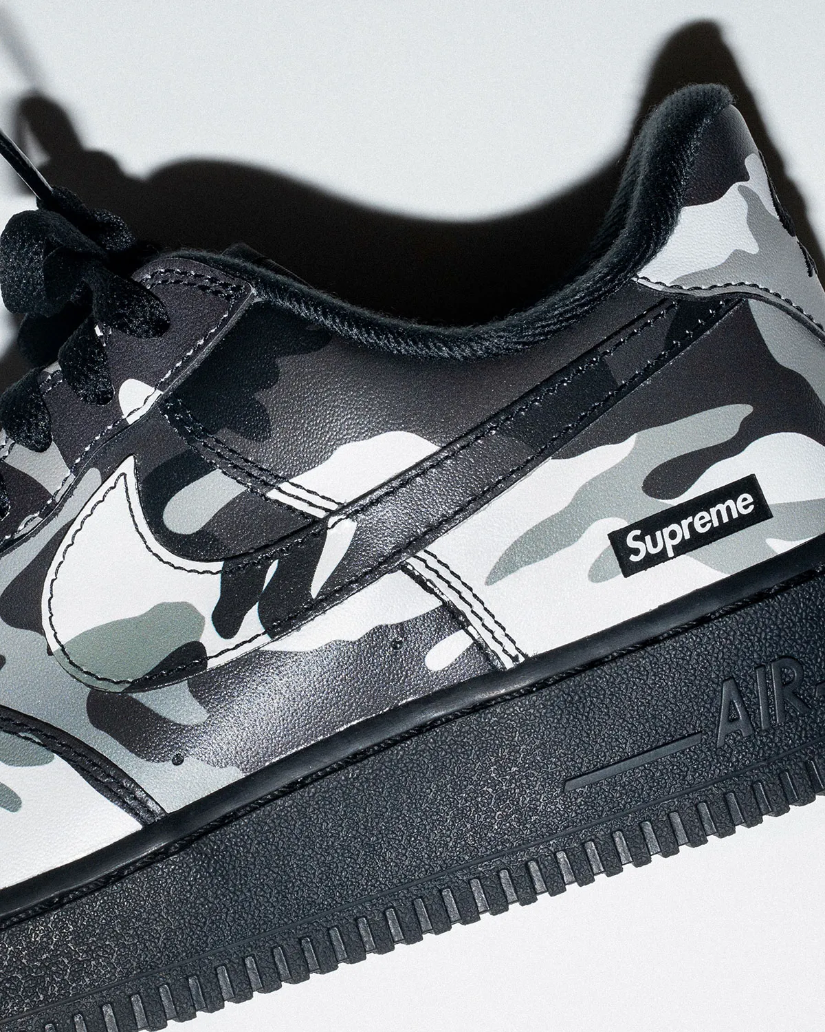 Top-down view of the Supreme x Nike Air Force 1 Snow Camo in its box