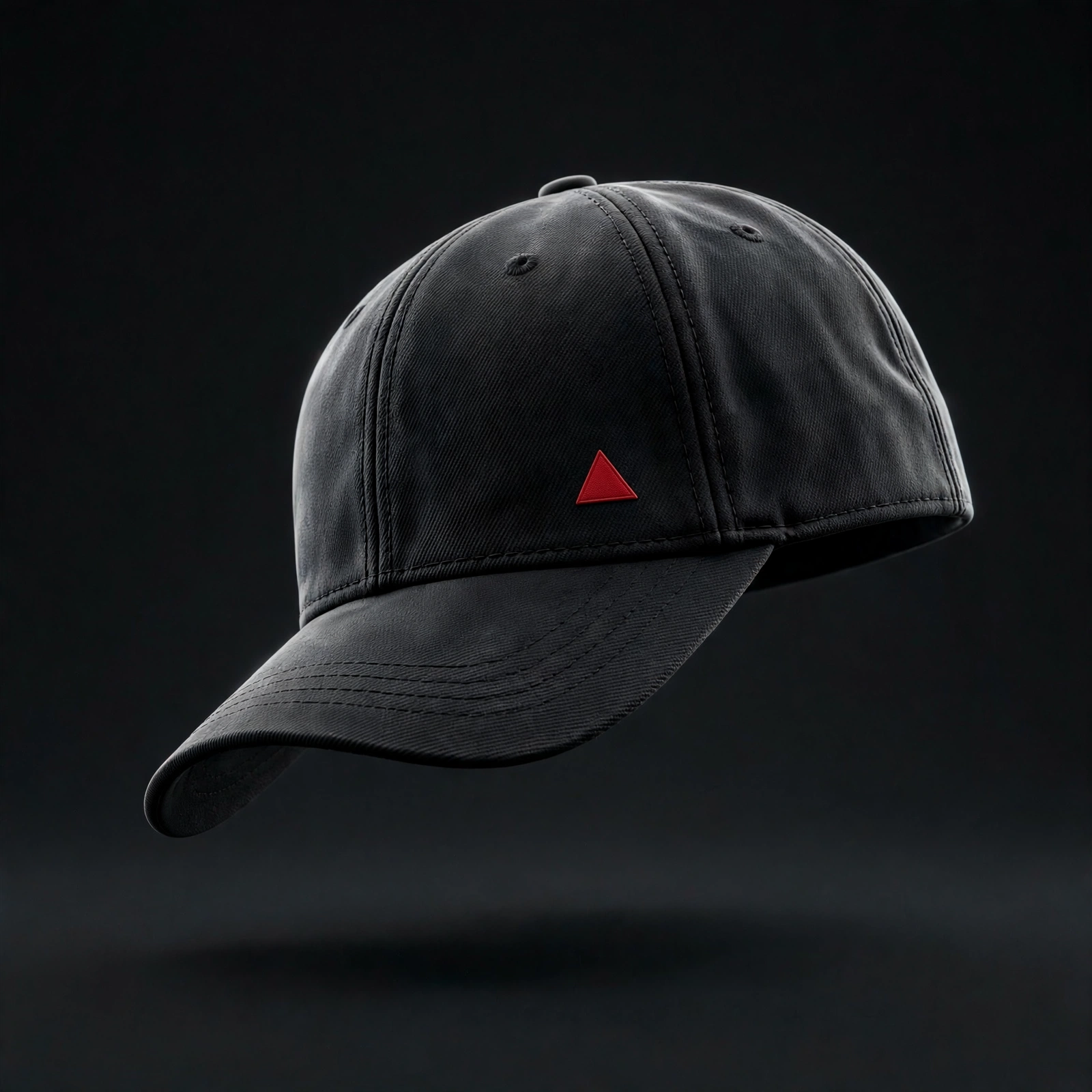 Black baseball cap with a small red triangle logo on a black background